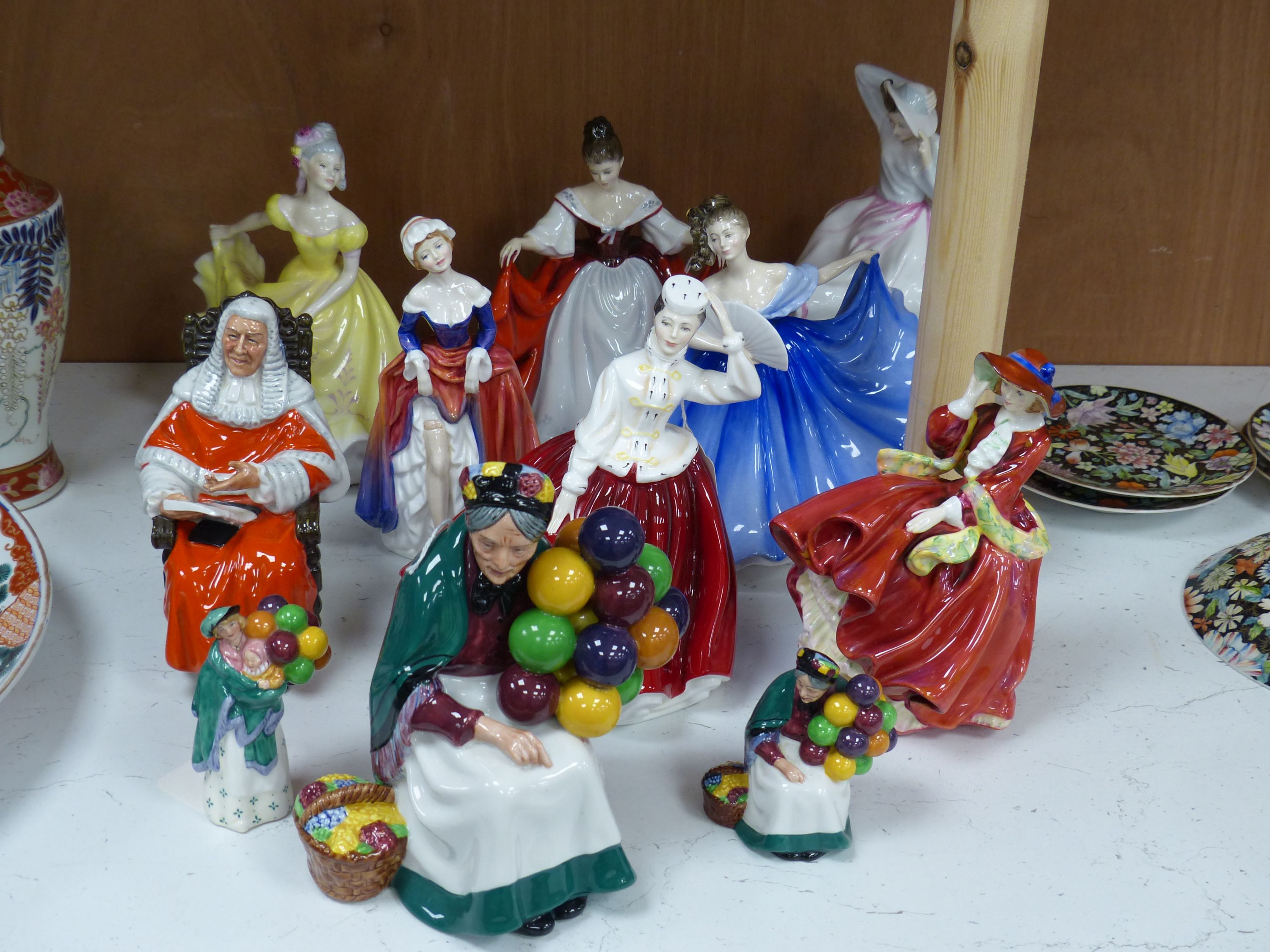 Ten Royal Doulton figurines, including 'Sara', 'The Judge', 'The Old Balloon Seller', 'Elaine' and others